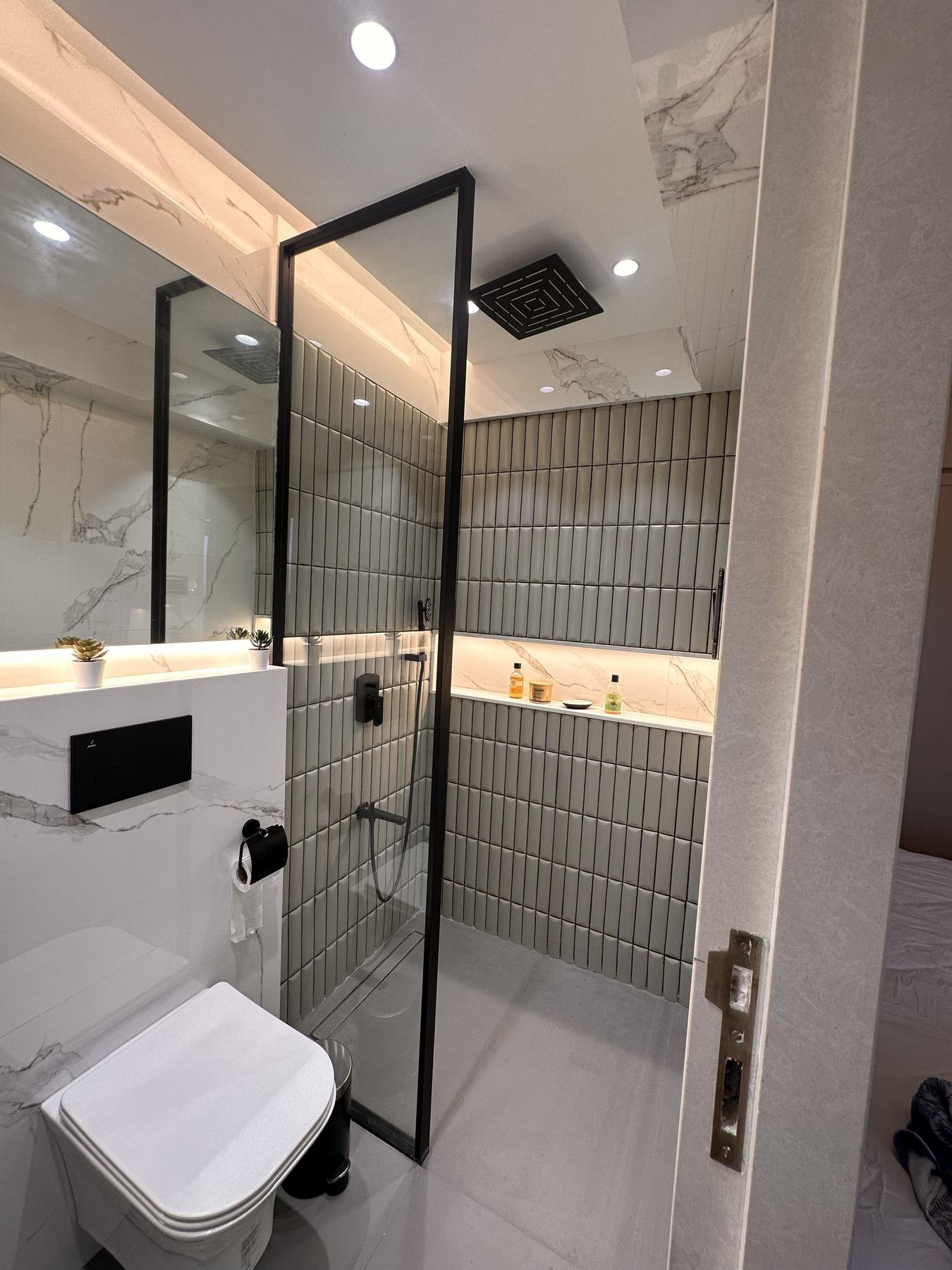 Bathroom with glass shower partition and designer tiles, Mumbai