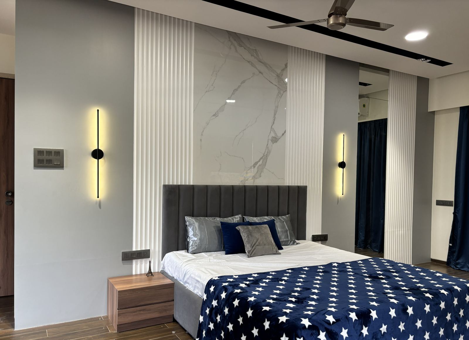 Navy blue bedroom with marble feature wall, residential interior design