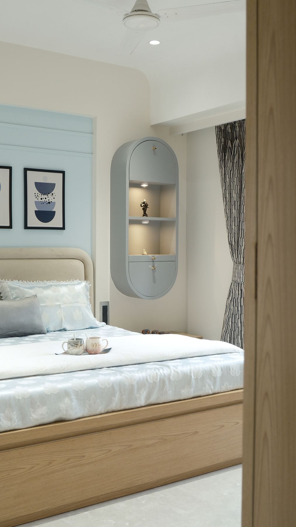 Bedroom detail with oval display niche and mirror, Mumbai interiors