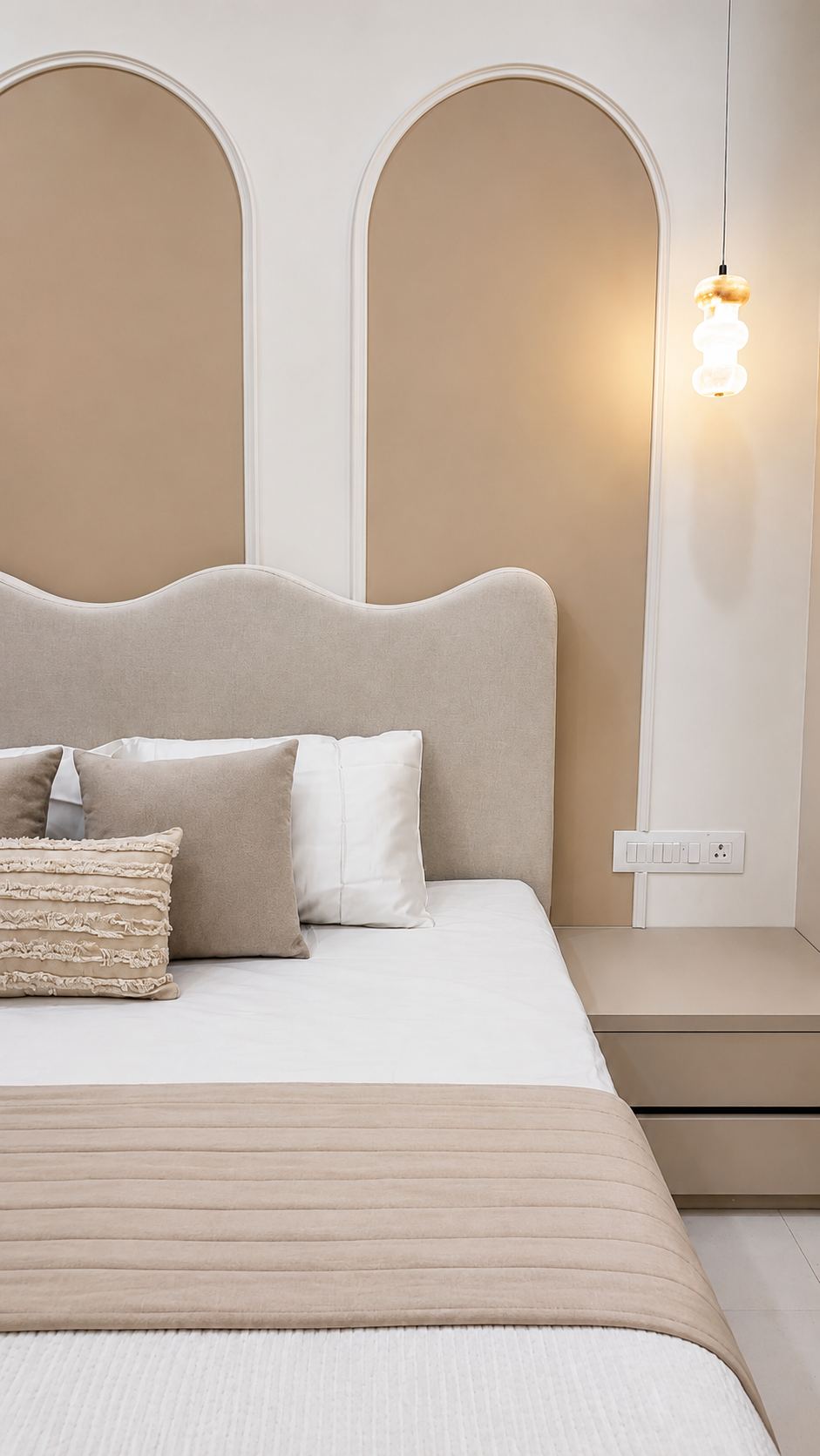 Bedroom with sculpted wavy headboard and arch wall panels