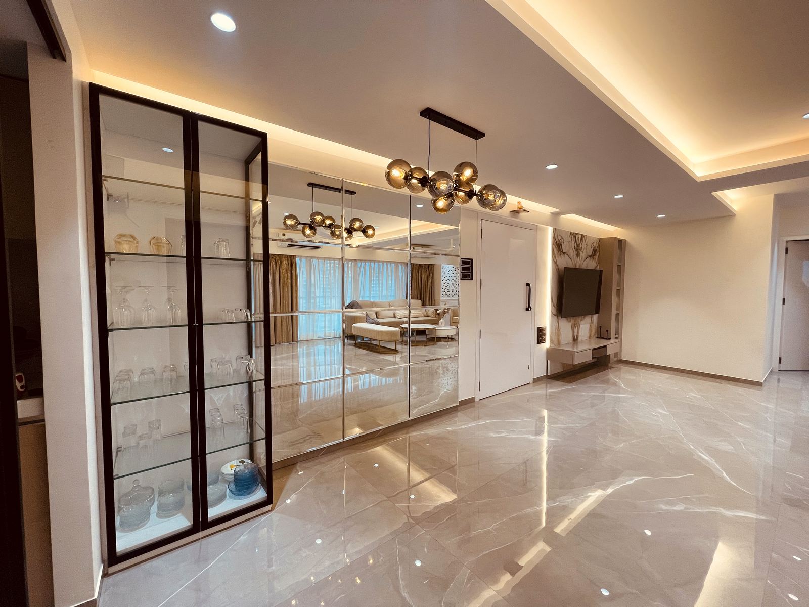 Foyer with mirror-backed crockery wall and marble flooring, luxury interiors Mumbai