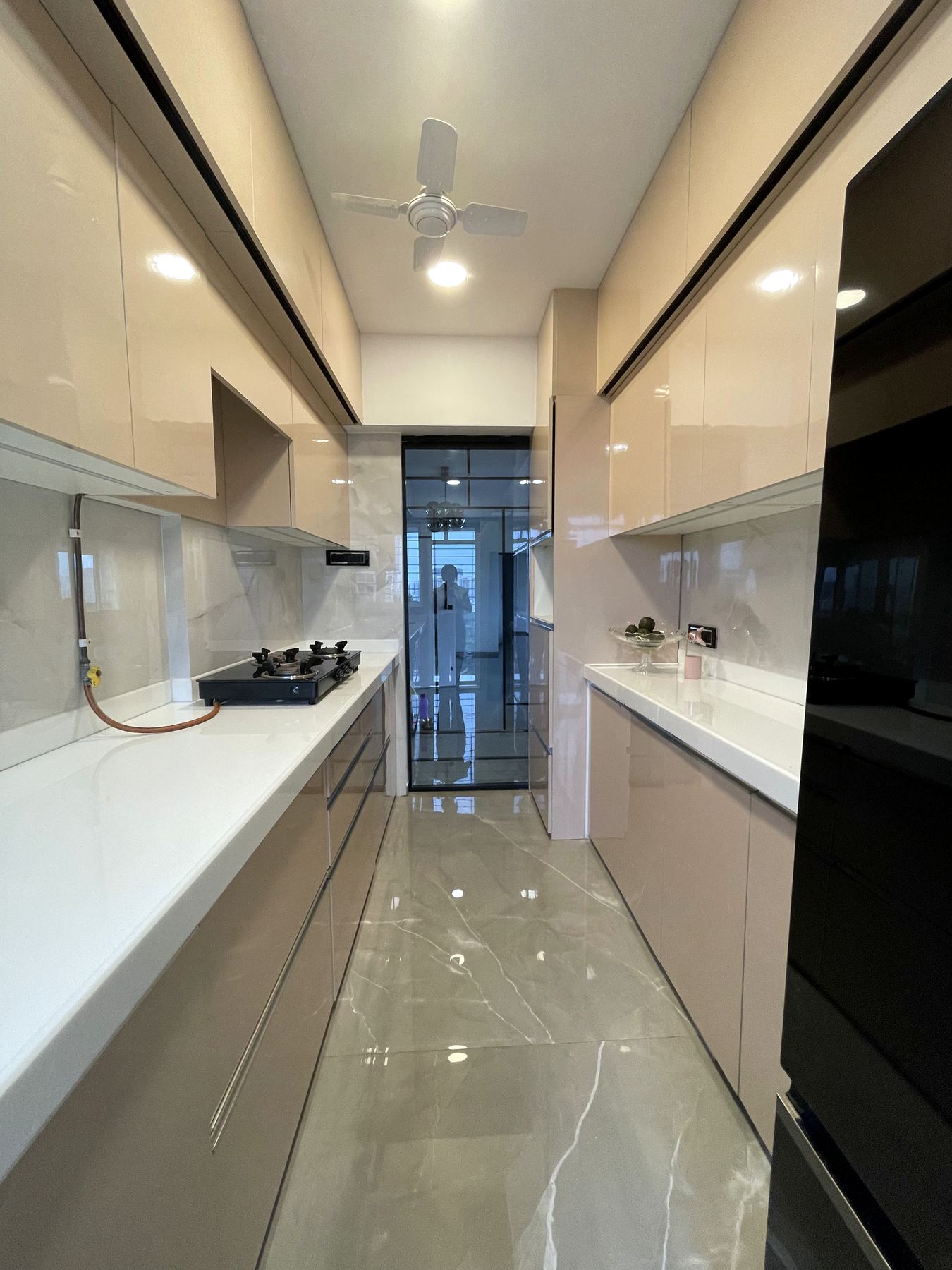 Glossy cream galley modular kitchen, Mumbai apartment