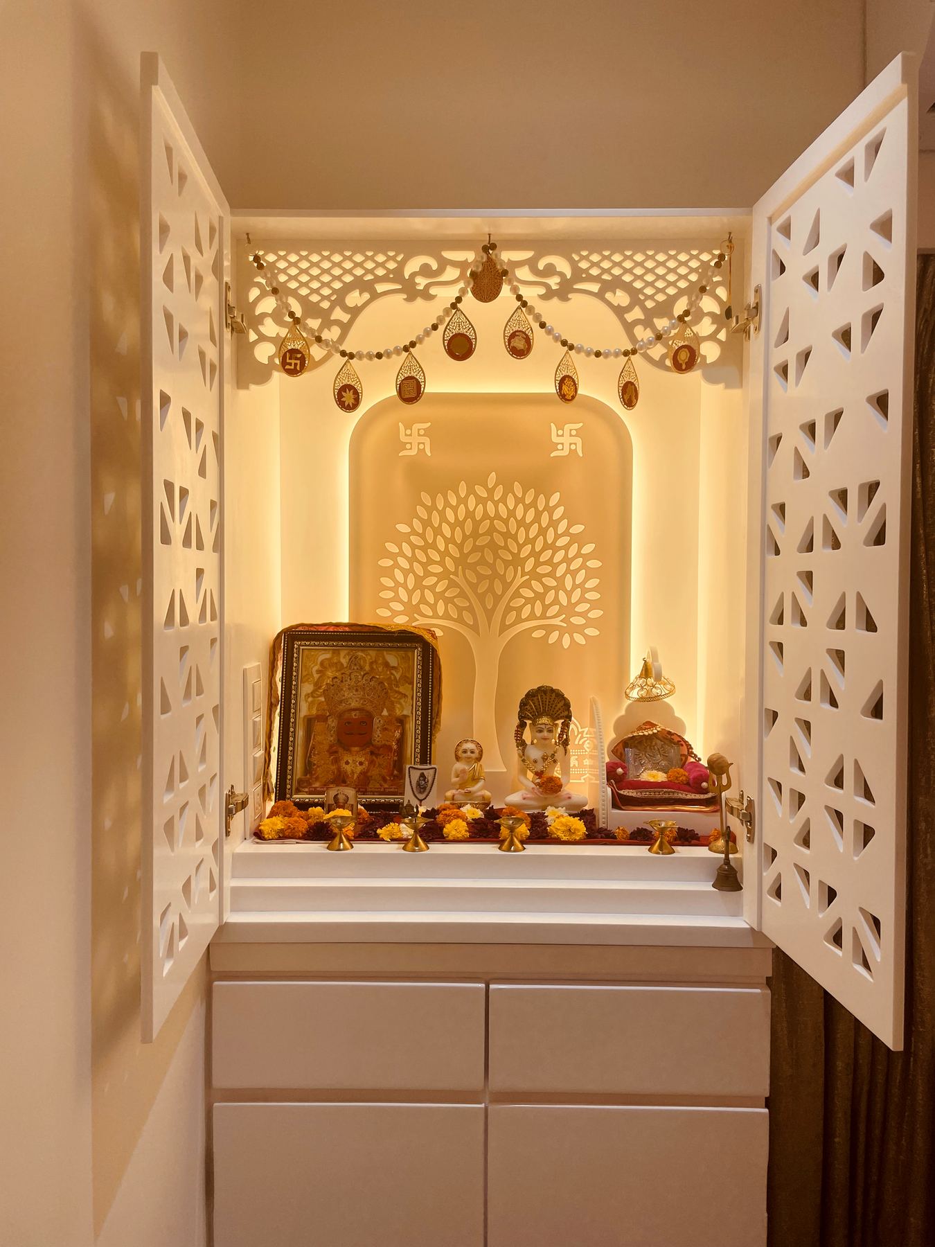 Pooja room with backlit jaali doors and marble platform, Mumbai