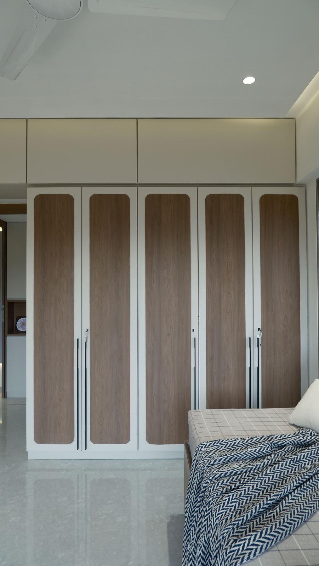 Wardrobes with fluted glass shutters and bench, Mumbai interiors