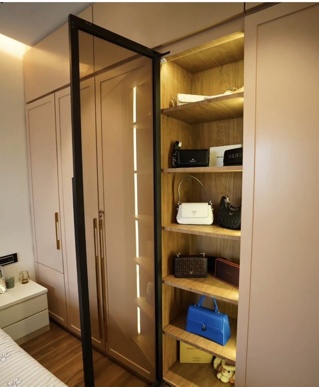 Wardrobe internals with backlit open shelves and accessories display